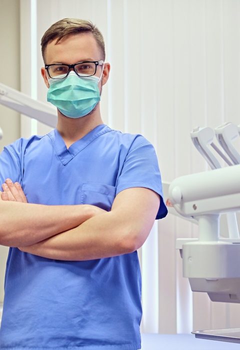 dentist-in-a-room-with-medical-equipment-on-background-.jpg